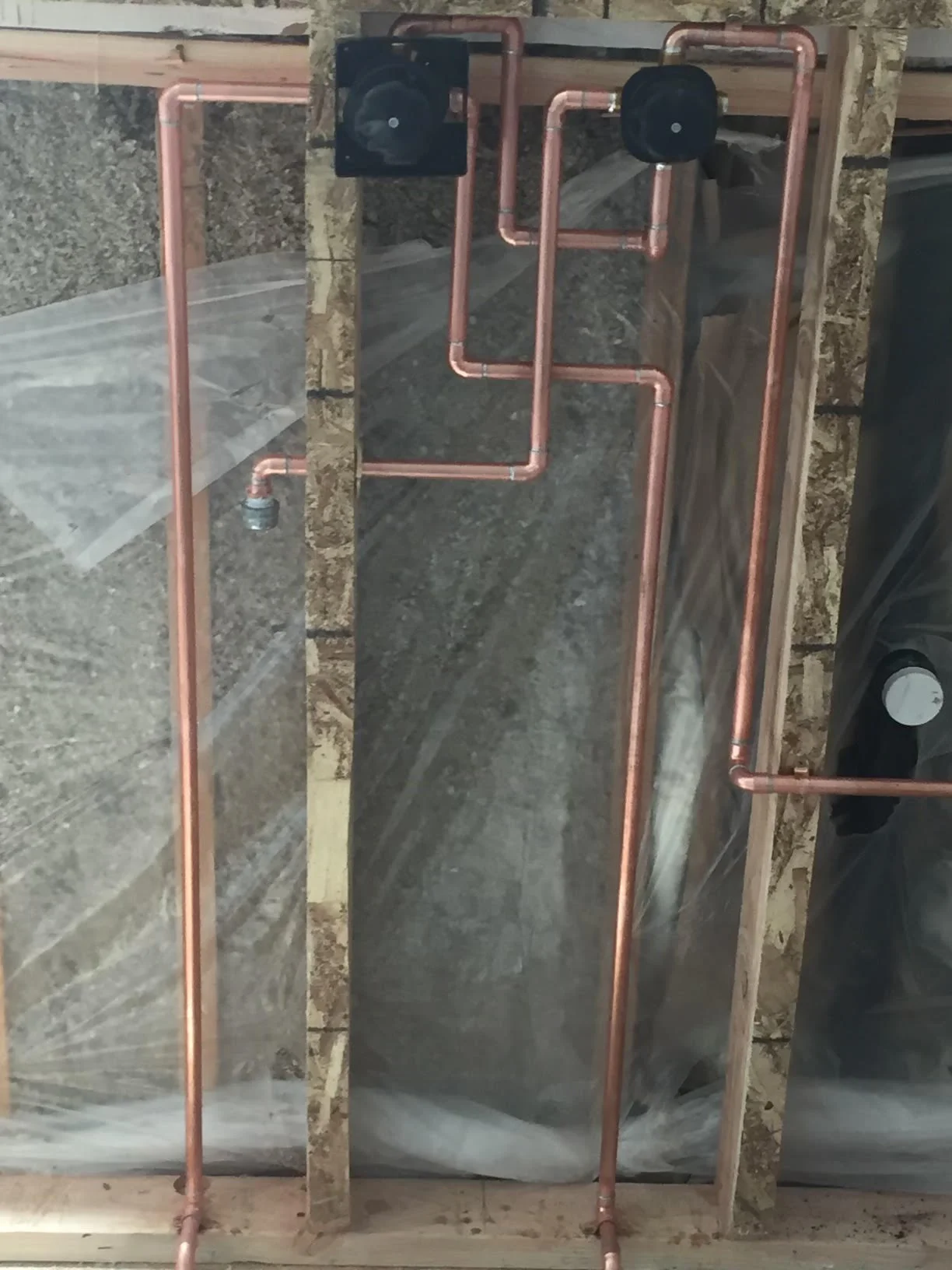 Copper radiant heating loops with isolation valves installed in concrete foundation